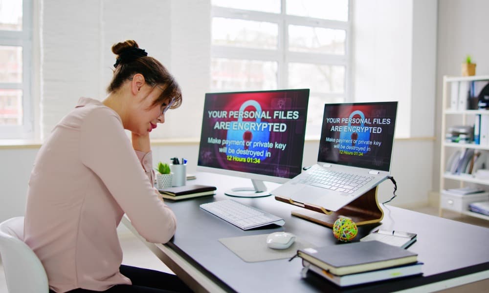 Victim of ransomware attack looks at computer screen