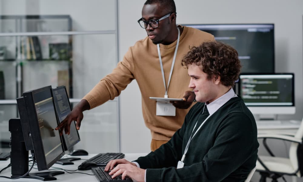 Proactive managed services provider’s representative training an employee as part of an I.T. business continuity planning strategy.